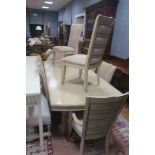 A CONTINENTAL CREAM PAINTED NINE PIECE DINING ROOM SUITE, comprising eight chairs,