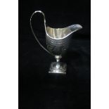 A GEORGE III BRIGHT CUT SILVER ENGRAVED CREAM JUG