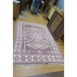 AN ORIENTAL RUG, the light brown,