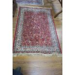A PERSIAN SILK AND WOOL RUG,