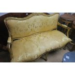 A CONTINENTAL GILTWOOD AND UPHOLSTERED SETTEE,