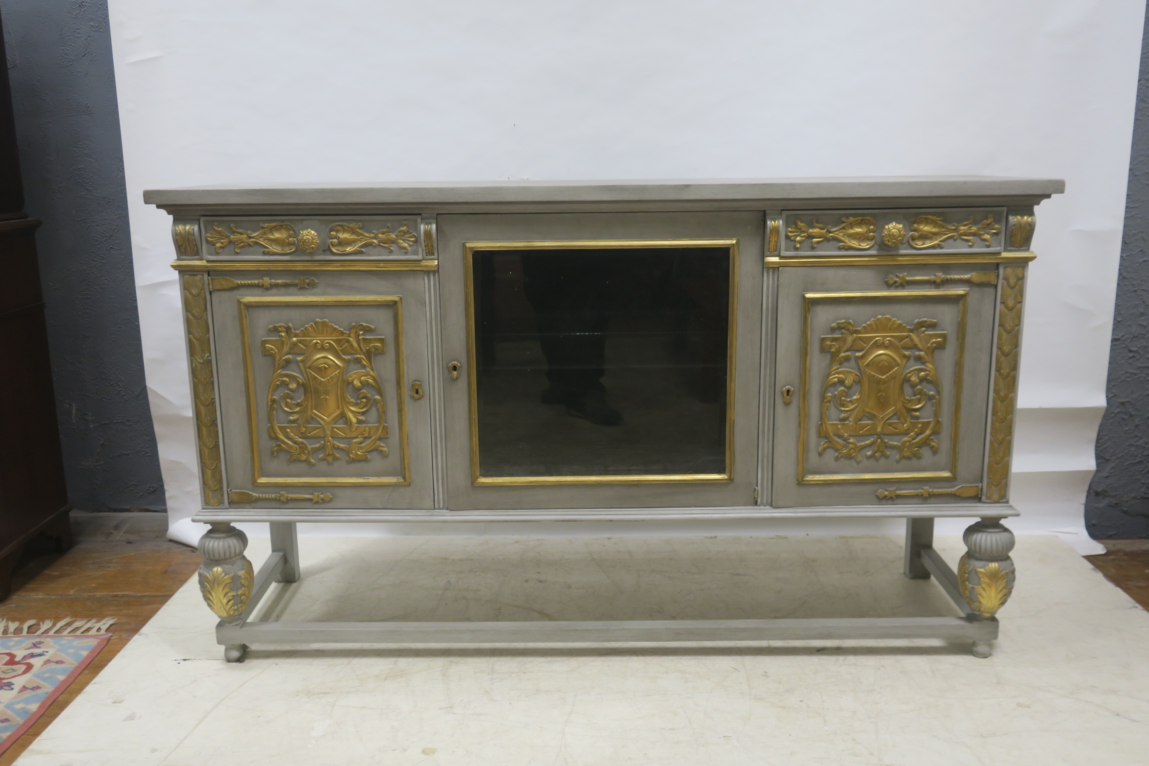 A CONTINENTAL GREY PAINTED AND PARCEL GILT SIDE CABINET,