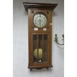 A PINE CASED WALL CLOCK,