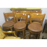 A GOOD SET OF OAK AND HIDE UPHOLSTERED REVOLVING HIGH STOOLS,