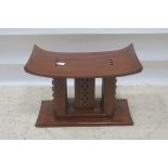 AN ASHANTI AFRICAN HARDWOOD STOOL 40cm (h) x 60cm (w) x 35cm (d)