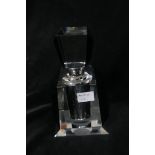 AN ART DECO DESIGN CLEAR GLASS AND BLACK GLASS PERFUME BOTTLE of rectangular spreading form with