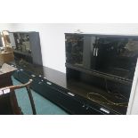 AN EBONISED AND SMOKED GLASS THREE PIECE WALL UNIT glazed doors and frieze drawers with cupboards