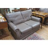 A CONTEMPORARY TWO SEATER HIDE UPHOLSTERED SETTEE,