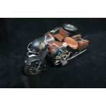 A TIN PLATE AND POLYCHROME MODEL OF A MOTORBIKE AND SIDECAR