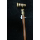 A HARDWOOD AND BRASS WALKING STICK,