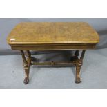 A VICTORIAN WALNUT FOLDOVER CARD TABLE the rectangular hinged top containing a baise lined interior