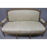 A 19th CENTURY CONTINENTAL GILTWOOD AND UPHOLSTERED SETTEE,