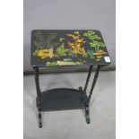 A BLACK LACQUERED AND POLYCHROME OCCASIONAL TABLE,