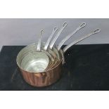 A SET OF FIVE COPPER GRADUATED SAUCEPANS,