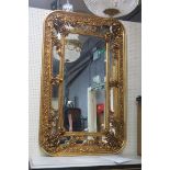 A CONTINENTAL GILTWOOD AND GESSO COMPARTMENTED MIRROR,
