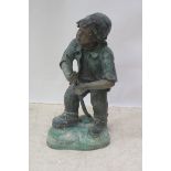 A BRONZE FIGURAL FOUNTAIN, modelled as a young boy shown standing on a rockwork base holding a pipe,