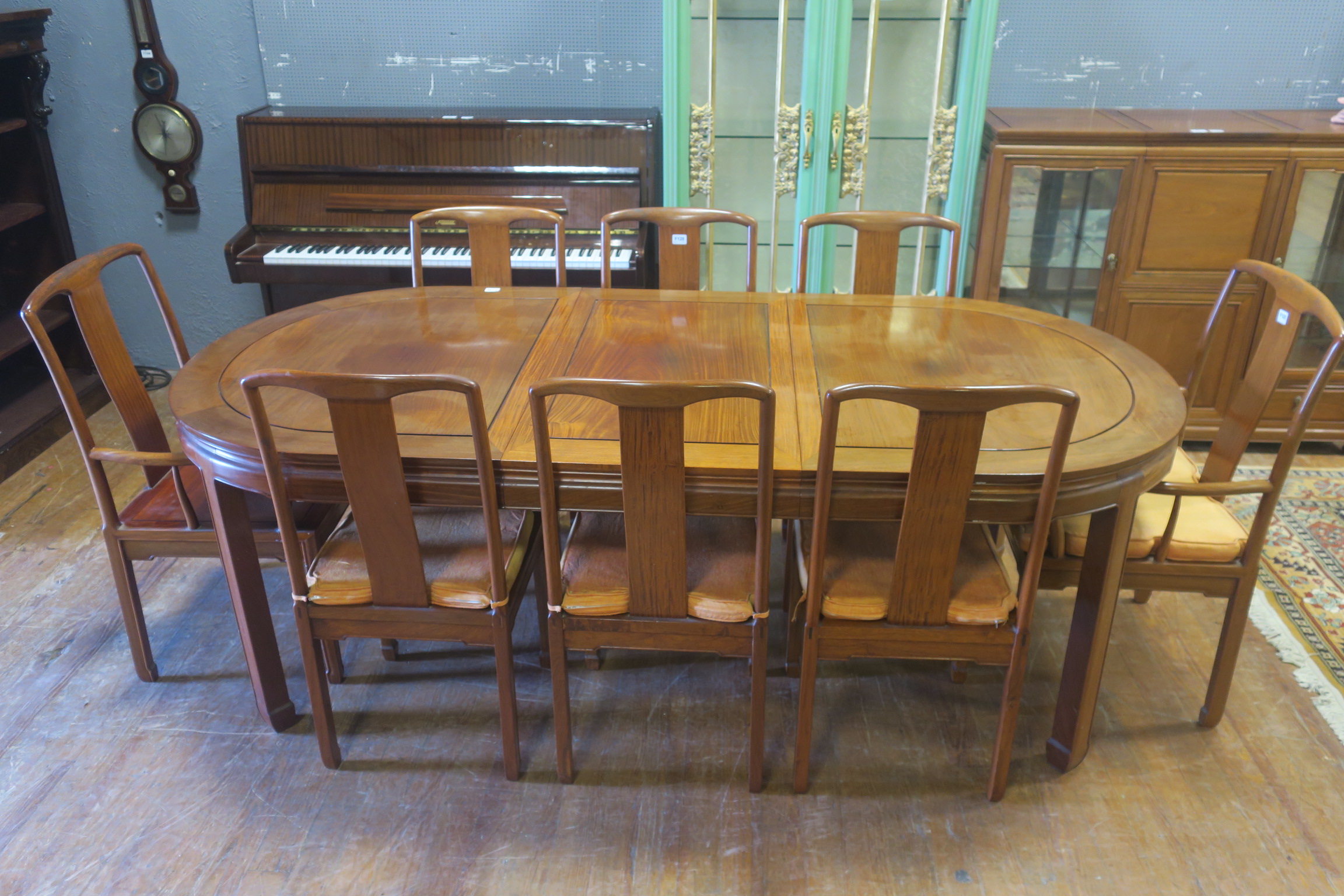 AN ORIENTAL HARDWOOD TWELVE PIECE DINING ROOM SUITE, comprising eight chairs,