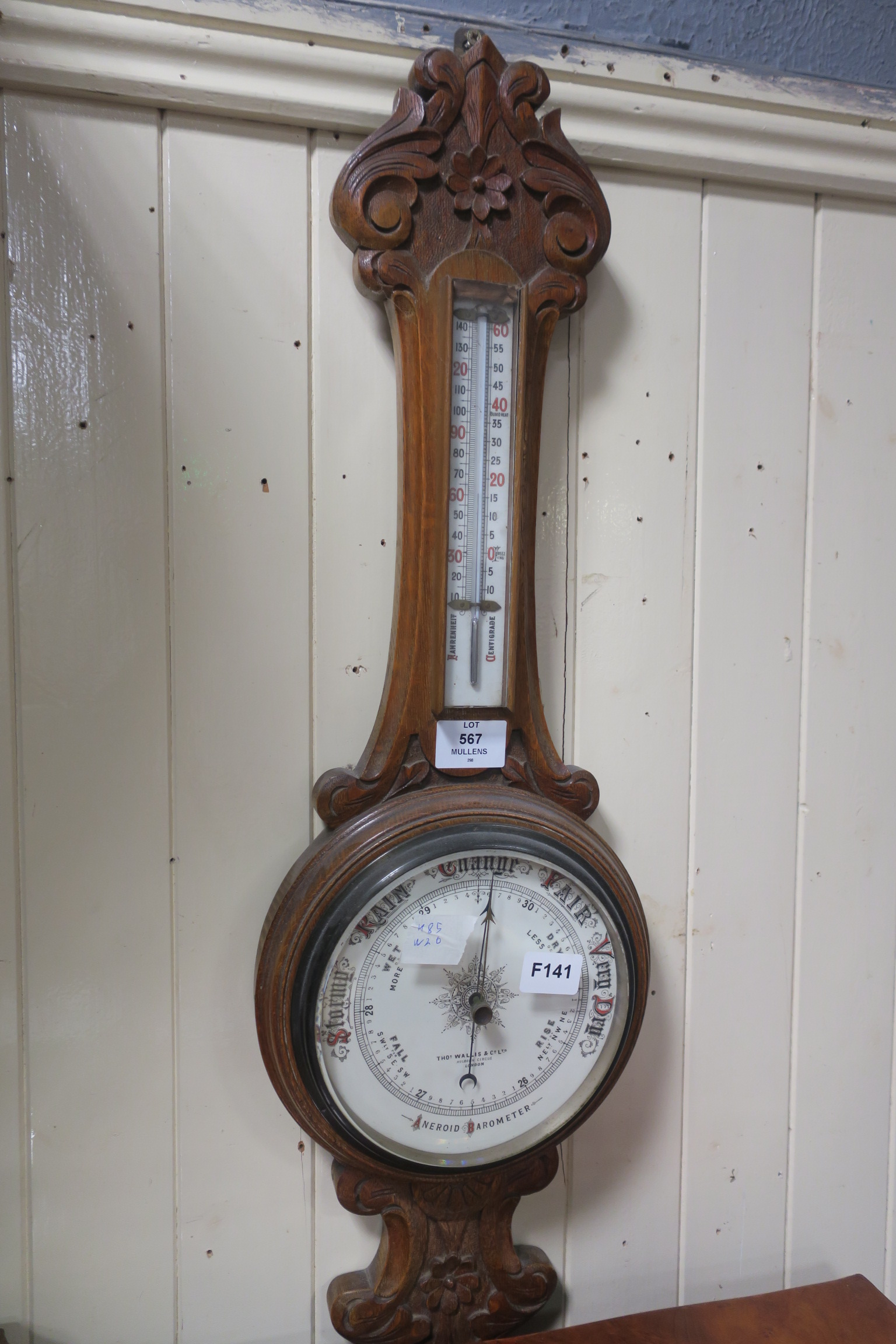 A 19th CENTURY CARVED OAK BANJO BAROMETER, inscribed 'Thos Wallis & Co., Ltd.