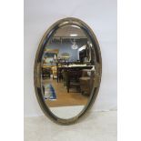 A GILT AND EBONISED MIRROR,