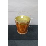 AN OYSTER WOOD AND BRASS BOUND RIBBED BUCKET,