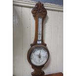 A 19th CENTURY CARVED OAK BANJO BAROMETER, inscribed 'Thos Wallis & Co., Ltd.