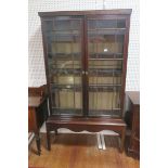 A GEORGIAN MAHOGANY BOOKCASE ON STAND,