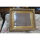 A CONTINENTAL GILT FRAMED MIRROR,