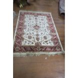 A BEIGE AND WINE GROUND PATTERN RUG,