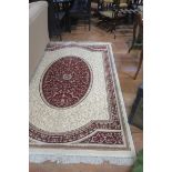 A BEIGE AND WINE GROUND PATTERN RUG,