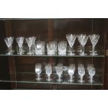 A COLLECTION OF DRINKING GLASSES, to include champagne flutes, sherry glasses, tumblers, etc.