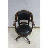 A MAHOGANY AND HIDE UPHOLSTERED SWIVEL OFFICE CHAIR The curved back with upholstered panel and seat