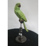 A COMPOSITION POLYCHROME FIGURE modelled as a parrot shown perched on a branch on a turned column