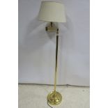 A BRASS ADJUSTABLE FLOOR STANDARD LAMP the cylindrical column on a circular spreading foot together