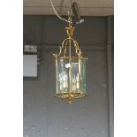 A BRASS AND GLAZED FOUR LIGHT HALL LANTERN,