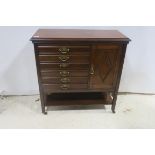 A 19TH CENTURY MAHOGANY SIDE CABINET of rectangular outline with six drop front drawers with brass