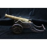 A 19TH CENTURY BRASS AND CAST IRON FIELD CANNON of typical form 22cm (h) x 46cm (l)