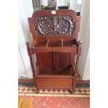 AN ARTS AND CRAFTS OAK THREE SECTION STICK STAND the shaped carved back above three open