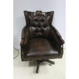 A FINE CONTINENTAL MAHOGANY PARCEL GILT AND HIDE UPHOLSTERED SWIVEL LIBRARY CHAIR with deep