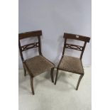 A SET OF SIX REGENCY DESIGN DINING CHAIRS each with a curved top rail and pierced splat above an