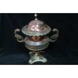 A 19th CENTURY COPPER AND BRASS LIDDED URN,