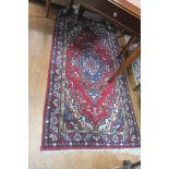 A PERSIAN WOOL RUG,