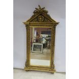 A CONTINENTAL GILT FRAME MIRROR, the triangular pediment with flowerheads,