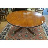 A FINE GEORGIAN MAHOGANY POD TABLE the circular top above a baluster column on quadruple splayed