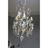 A CONTINENTAL GILT BRASS AND CUT GLASS SIX BRANCH CHANDELIER,