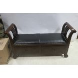 A HARDWOOD AND HIDE UPHOLSTERED SEAT with scroll arms and frieze drawers on scroll legs 70cm (h) x