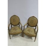 A GOOD PAIR OF 19TH CENTURY FRENCH GILT WOOD AND NEEDLE WORK SALON CHAIRS each with a foliage