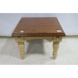 A HARDWOOD AND POLYCHROME COFFEE TABLE,