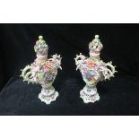 A PAIR OF CONTINENTAL PORCELAIN FLOWER ENCRUSTED LIDDED VASES,