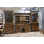 A 19TH CENTURY CARVED OAK SIDEBOARD with bevelled glass panels and carved door cupboard above two