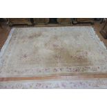A CHINESE WOOL RUG beige and cream ground with central floral panel with a conforming boarder 360cm